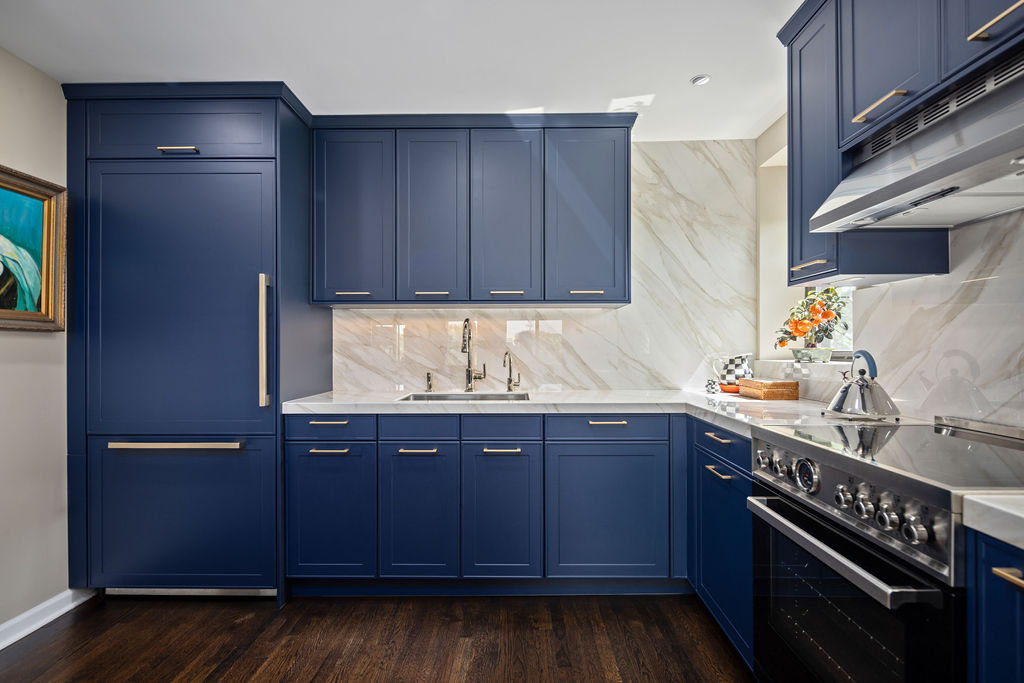 Navy blue kitchen cabinets with a smooth satin finish painted by an interior painter in St. Petersburg, FL.
